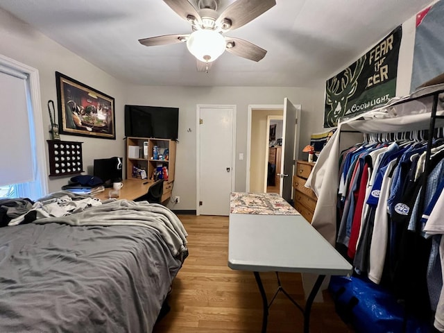 bedroom featuring ceiling fan, light hardwood / wood-style floors, and a closet