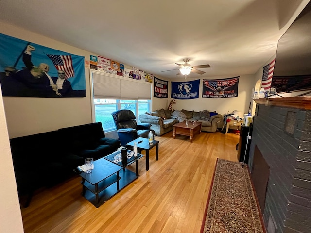 living room with ceiling fan and light hardwood / wood-style floors