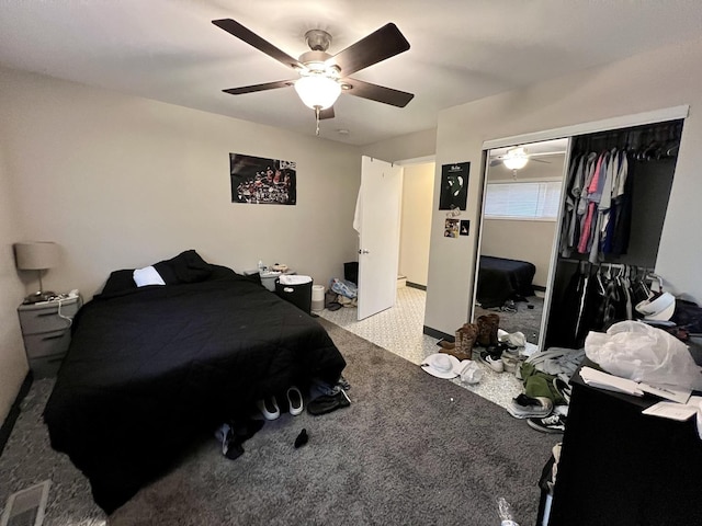 carpeted bedroom featuring ceiling fan and a closet