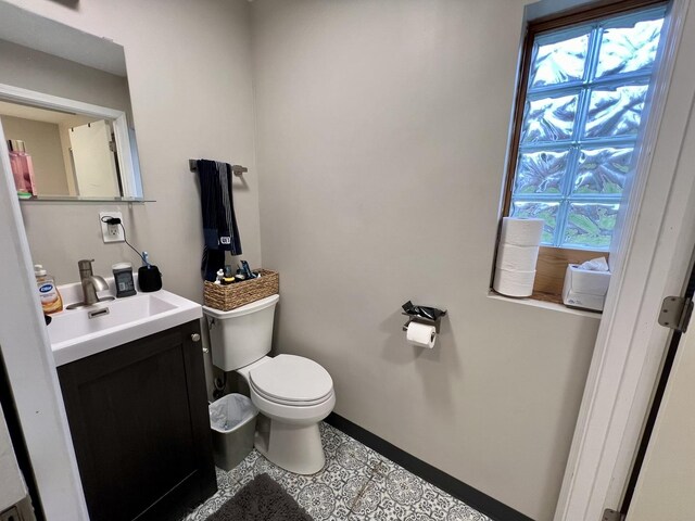 bathroom featuring tile patterned floors, vanity, and toilet
