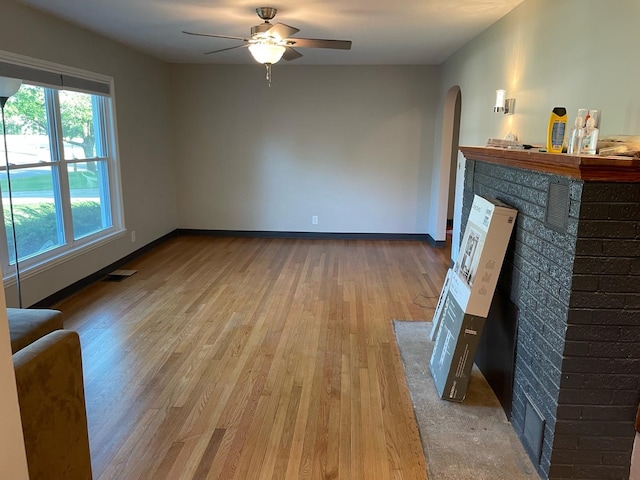 living room with light hardwood / wood-style floors and ceiling fan