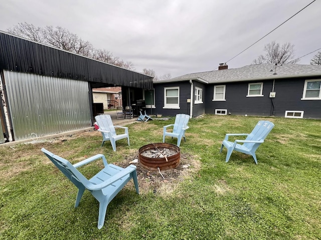 view of yard featuring an outbuilding and a fire pit