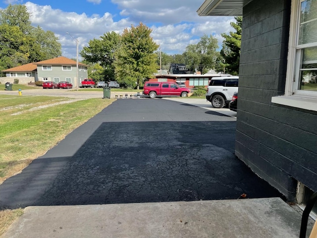 view of parking / parking lot with a yard