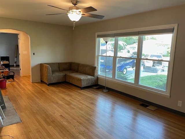 unfurnished living room featuring ceiling fan and light hardwood / wood-style flooring
