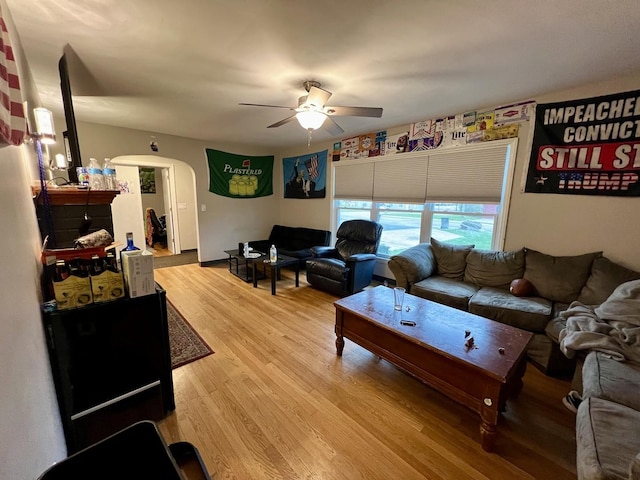 living room featuring ceiling fan and light hardwood / wood-style flooring