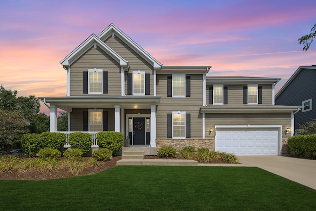 view of front of home with a garage and a lawn