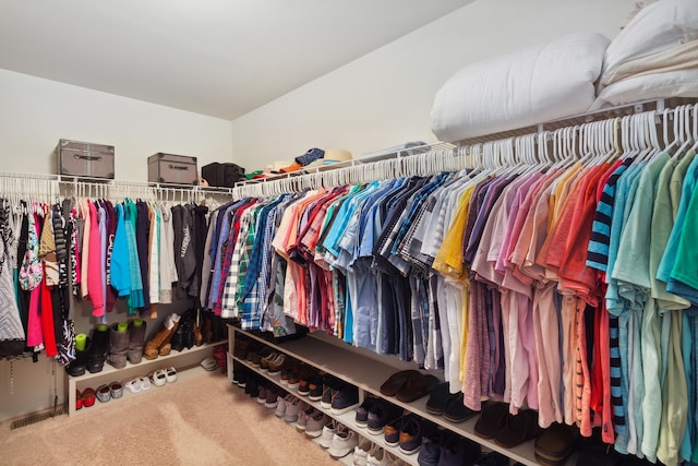 walk in closet with carpet