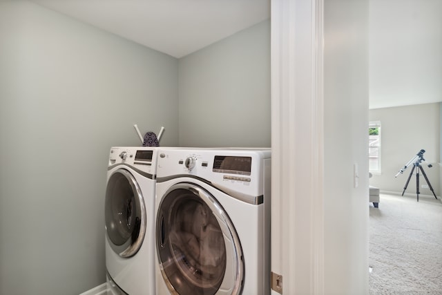 clothes washing area with separate washer and dryer and carpet