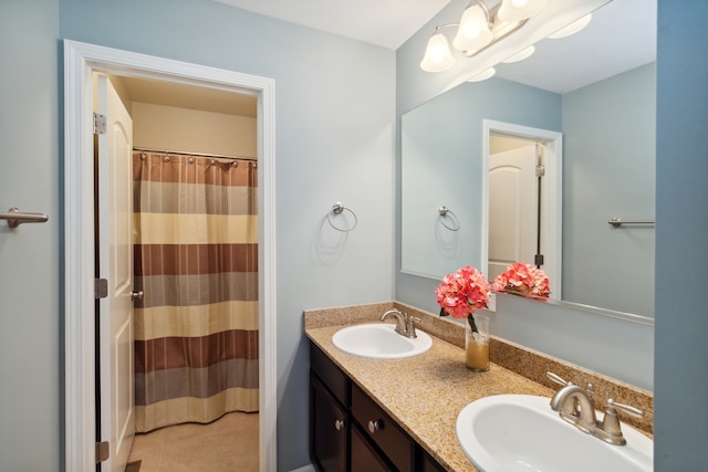 bathroom with tile patterned flooring and vanity