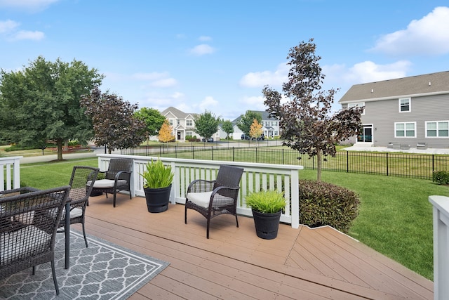 wooden terrace featuring a yard