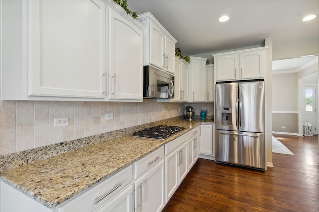 kitchen with white cabinets, stainless steel appliances, and dark hardwood / wood-style floors