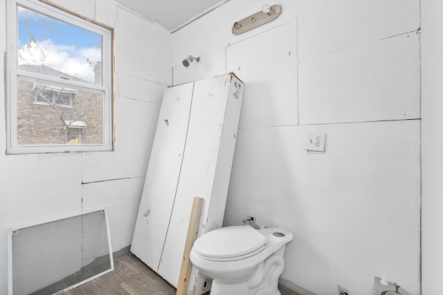 bathroom featuring hardwood / wood-style flooring and toilet