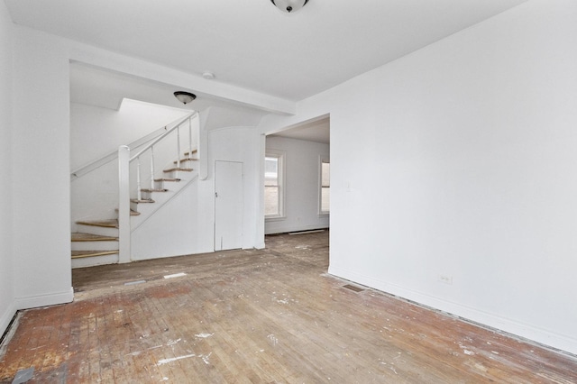 unfurnished living room with wood-type flooring