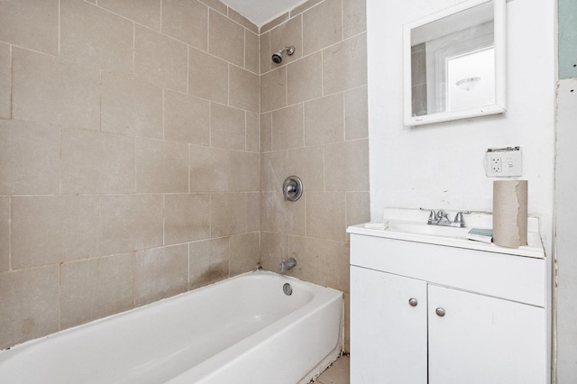 bathroom with vanity and tiled shower / bath combo