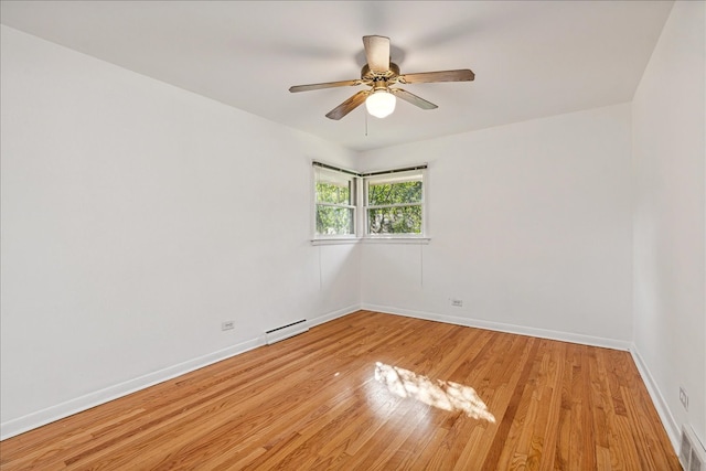 empty room with a baseboard radiator, light hardwood / wood-style flooring, and ceiling fan