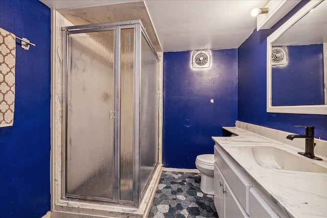 bathroom with walk in shower, vanity, and toilet