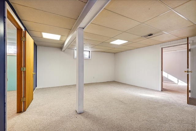 basement featuring carpet flooring and a drop ceiling