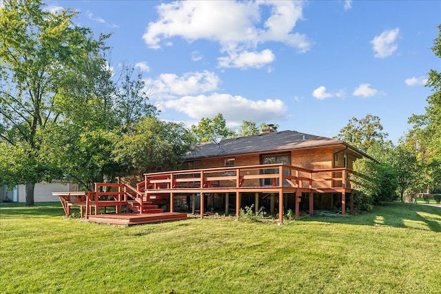 rear view of house featuring a deck and a yard