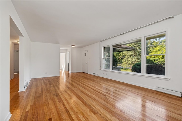 interior space featuring light hardwood / wood-style floors and baseboard heating