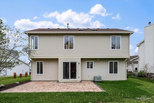 back of property featuring a lawn, central air condition unit, and a patio