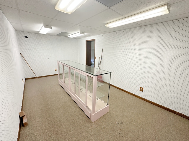 empty room with a paneled ceiling and carpet