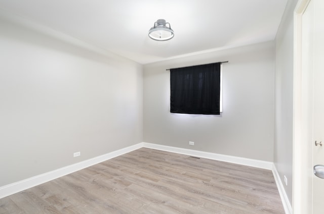 spare room with light wood-type flooring