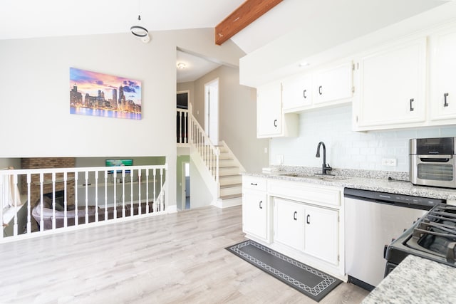 kitchen with decorative backsplash, light wood-type flooring, light stone counters, lofted ceiling with beams, and white cabinetry