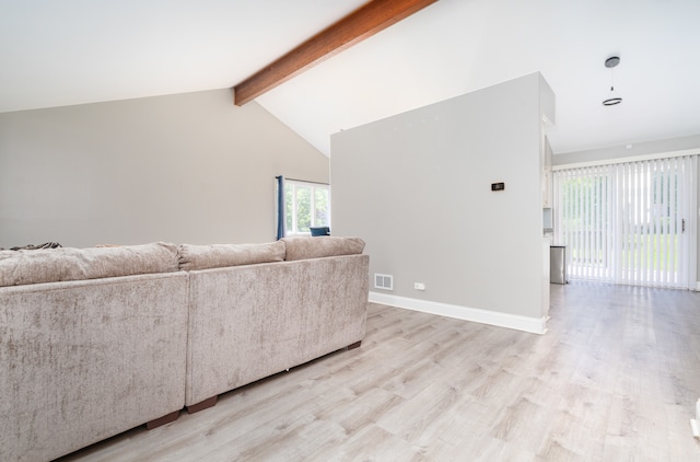 unfurnished living room featuring beam ceiling, high vaulted ceiling, and light hardwood / wood-style flooring