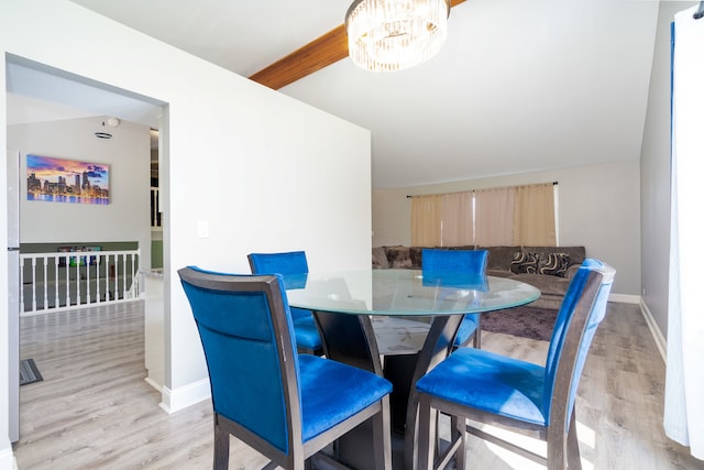 dining area with a notable chandelier, vaulted ceiling with beams, and light hardwood / wood-style floors