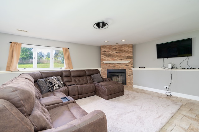 living room featuring a brick fireplace