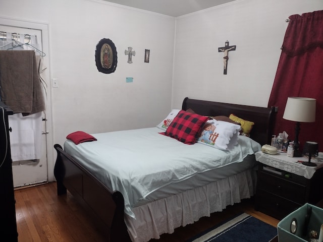 bedroom featuring dark hardwood / wood-style flooring and crown molding