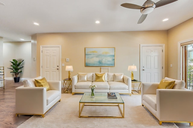 living room featuring ceiling fan and light hardwood / wood-style flooring