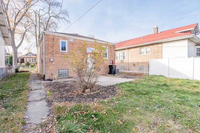 back of house with a yard and a patio area