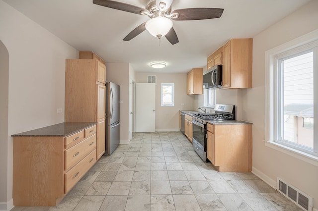 kitchen featuring appliances with stainless steel finishes, light brown cabinets, ceiling fan, and sink