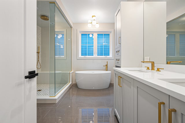 bathroom with tile patterned floors, vanity, and shower with separate bathtub