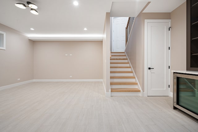 basement with light hardwood / wood-style floors