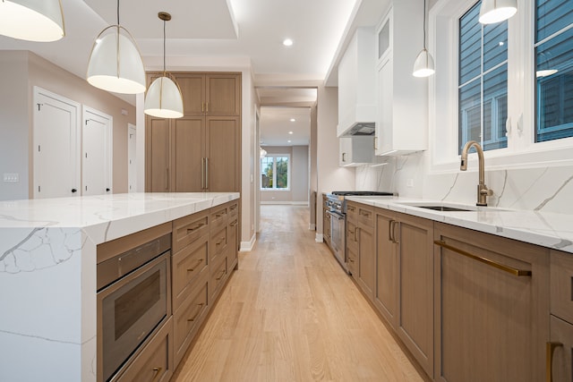 kitchen featuring white cabinets, backsplash, hanging light fixtures, and stainless steel appliances