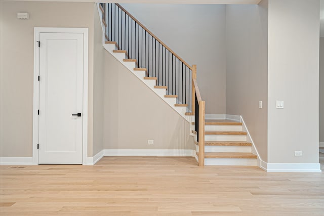 stairway with hardwood / wood-style flooring