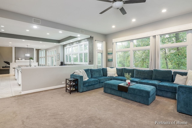 carpeted living room featuring ceiling fan