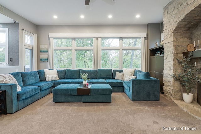 living room with ceiling fan and light carpet