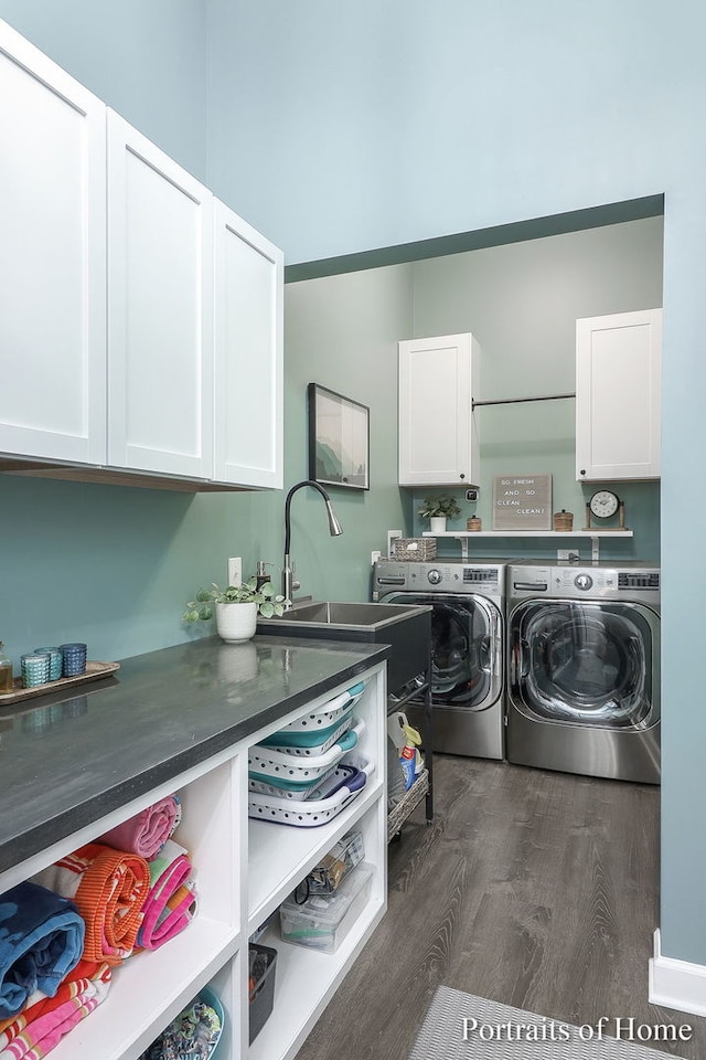 clothes washing area featuring sink, cabinets, dark hardwood / wood-style floors, and independent washer and dryer