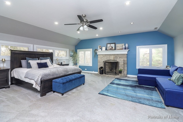 bedroom featuring light carpet, vaulted ceiling, multiple windows, and ceiling fan