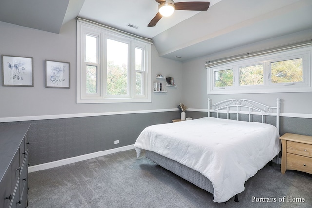 carpeted bedroom with vaulted ceiling, multiple windows, and ceiling fan