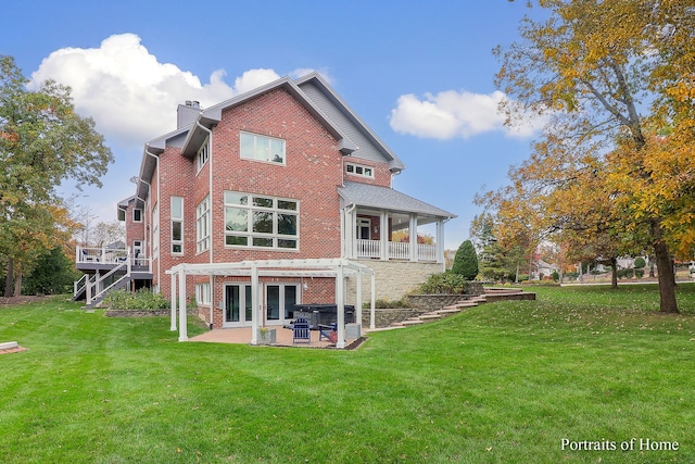 rear view of house featuring a pergola, a yard, and a patio