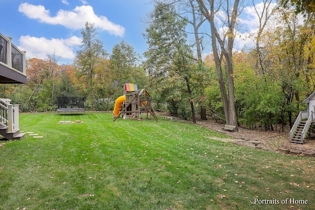 view of yard with a playground and a trampoline