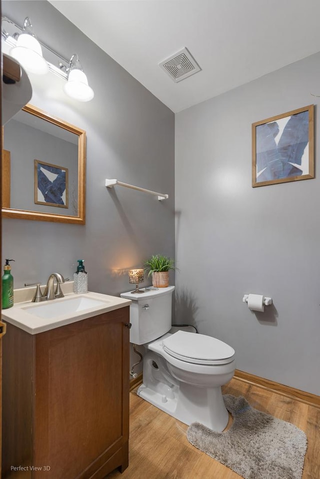 bathroom featuring hardwood / wood-style floors, vanity, and toilet