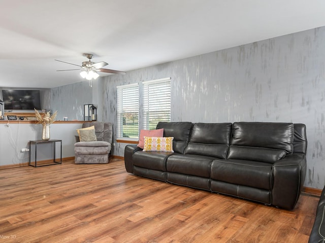 living room with ceiling fan and light hardwood / wood-style floors