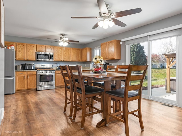 dining space featuring light hardwood / wood-style flooring and ceiling fan