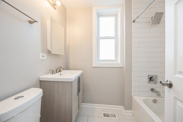 full bathroom featuring tile patterned flooring, vanity, tiled shower / bath combo, and toilet