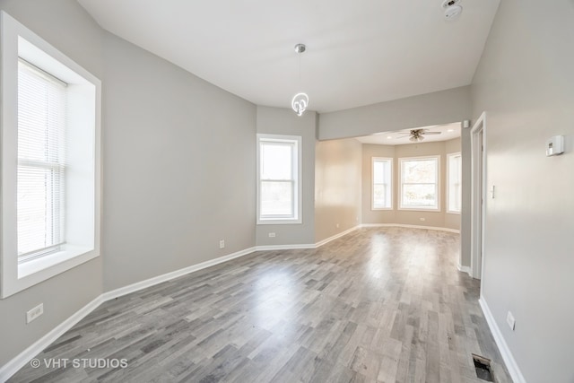 spare room featuring light hardwood / wood-style flooring and ceiling fan